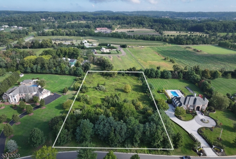 an aerial view of a houses with a yard