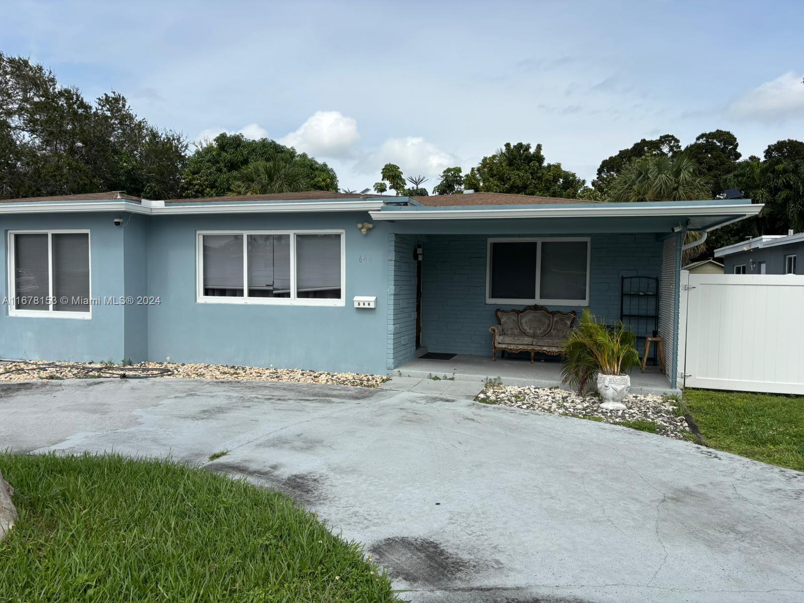 a view of a house with a patio and a yard