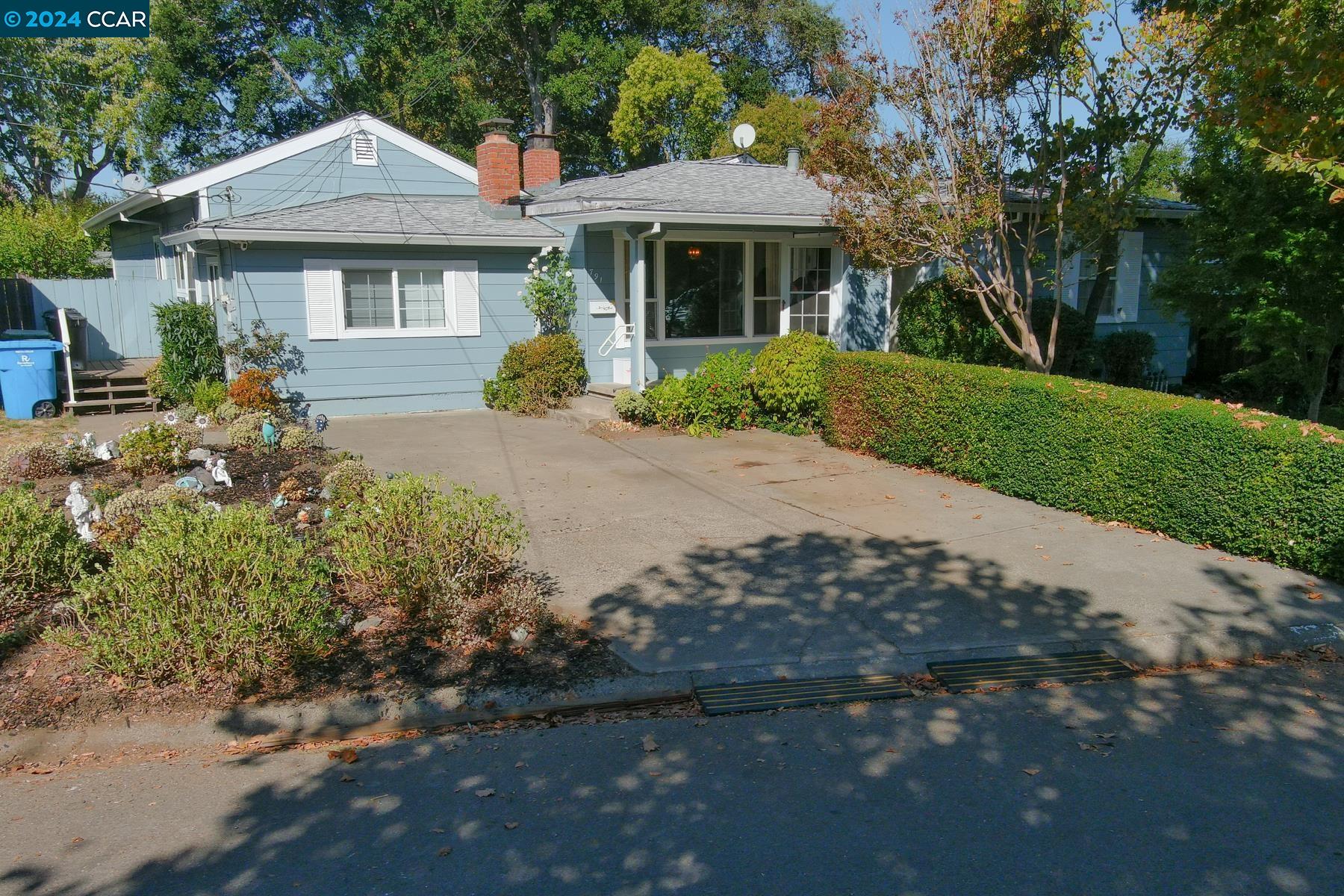 a front view of a house with a garden