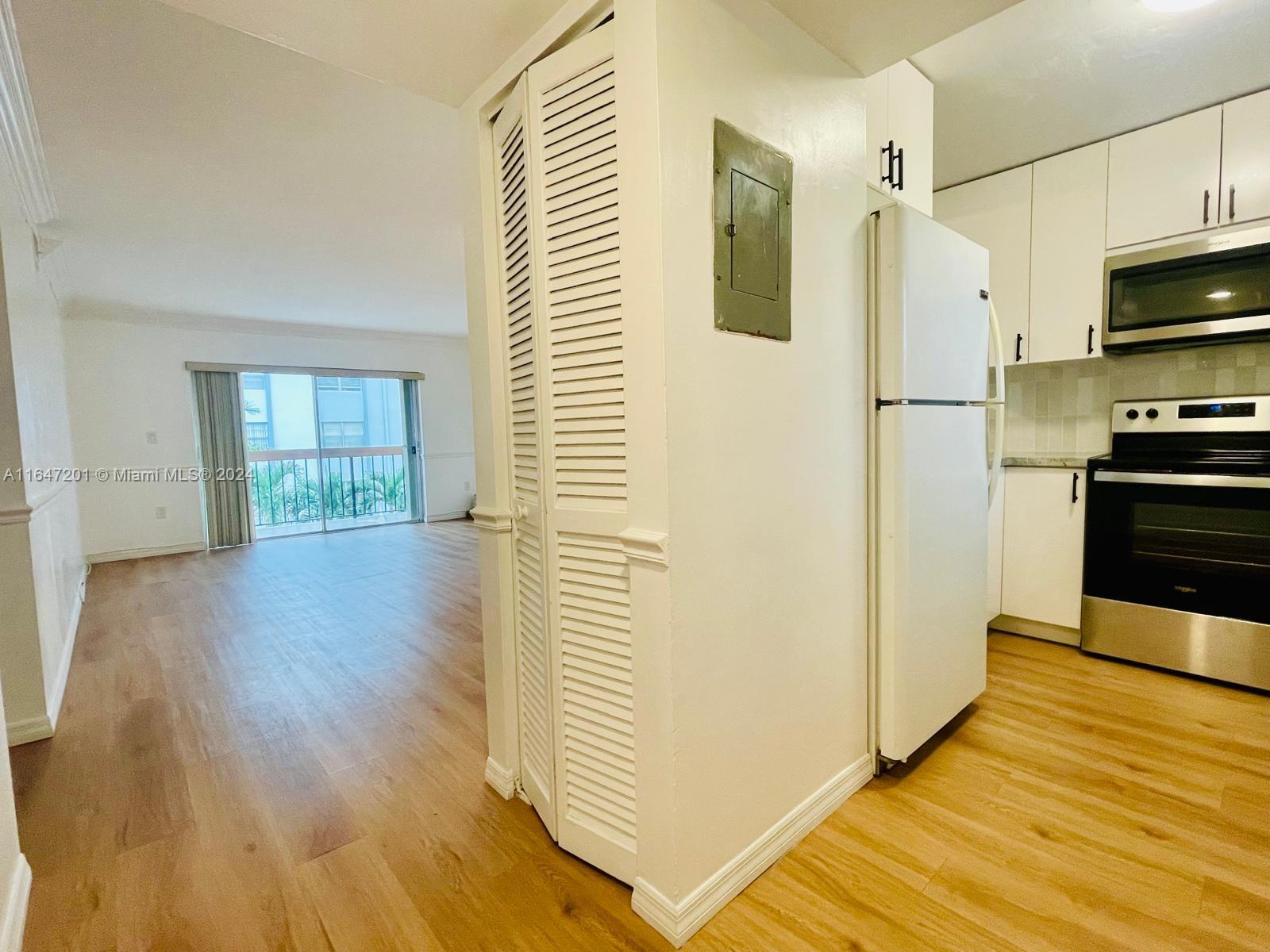 a view of a kitchen from the hallway