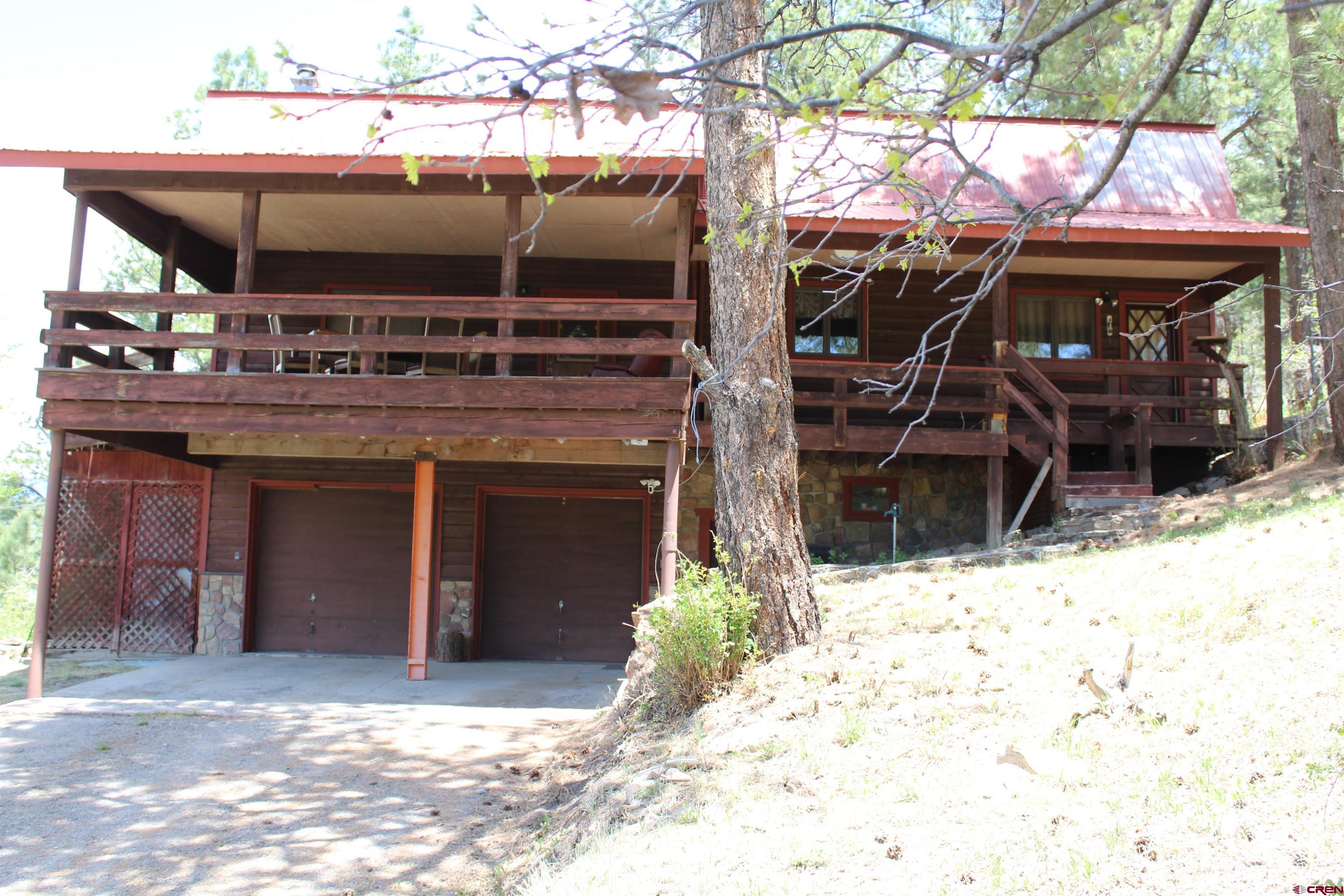 a view of a house with a yard and garage