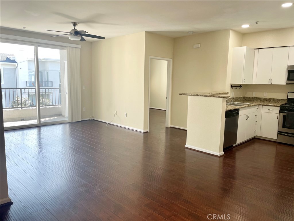 a view of a kitchen with a stove wooden floor and a kitchen