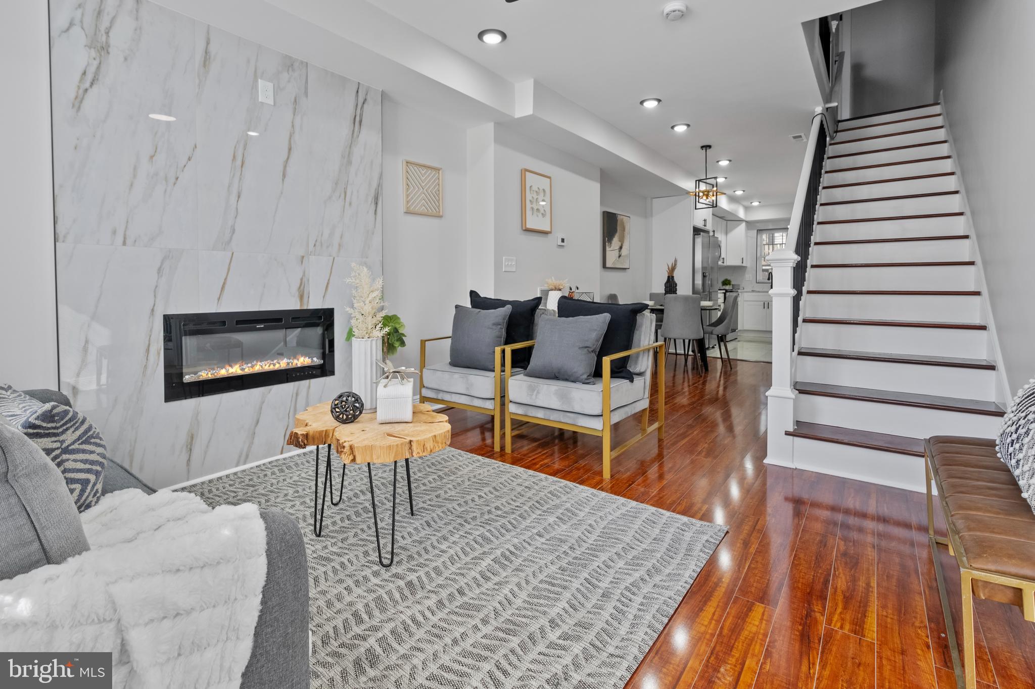 a living room with furniture a rug and white walls