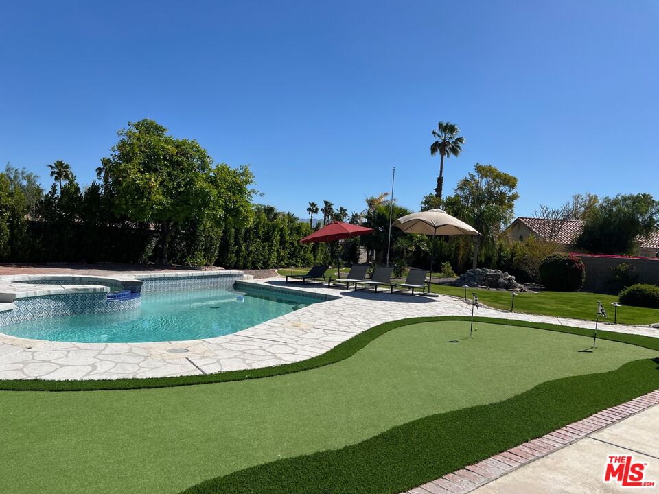 a view of a swimming pool with a yard