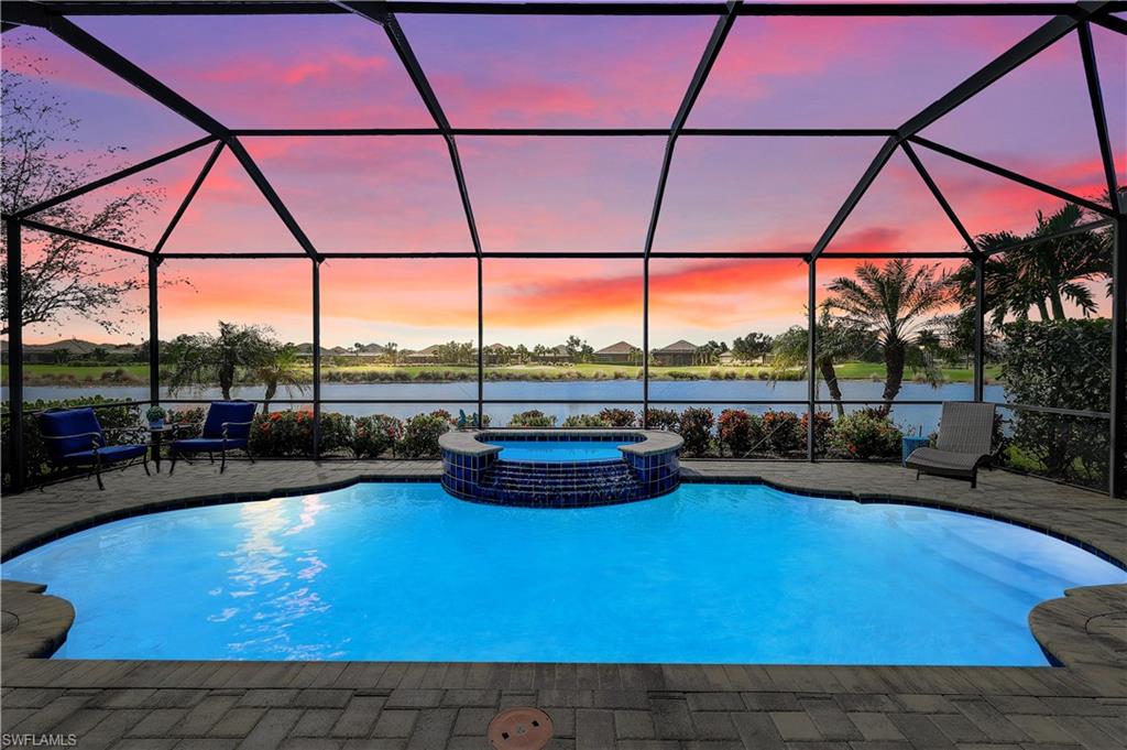 a view of a swimming pool and lounge chairs in patio