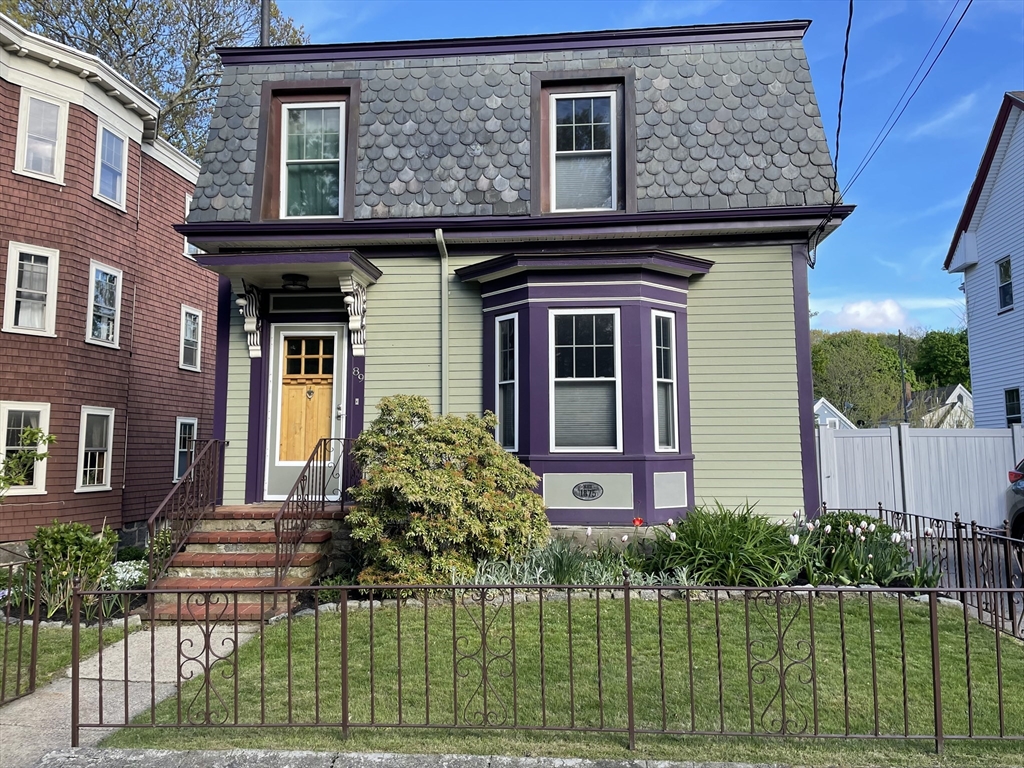 a front view of a house with a garden