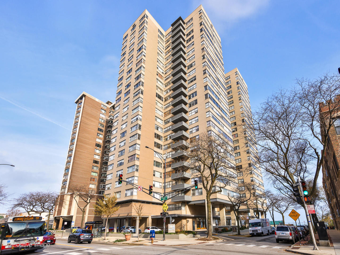 a view of a tall building next to a road