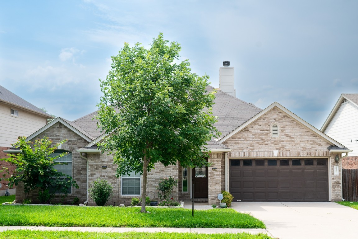 a front view of a house with a garden