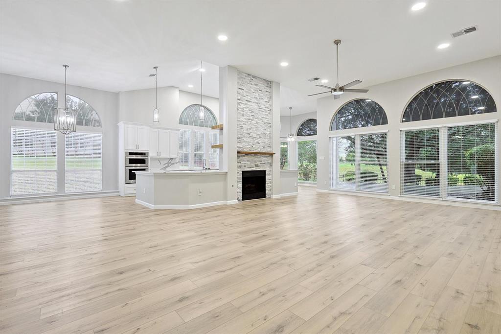 an open kitchen with wooden floors and wide window