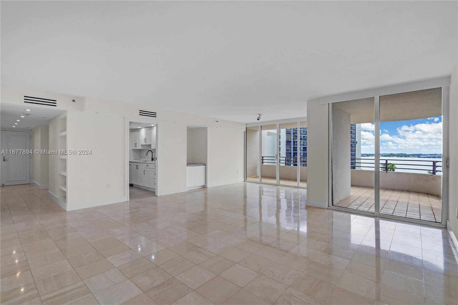 an empty room with fireplace and windows