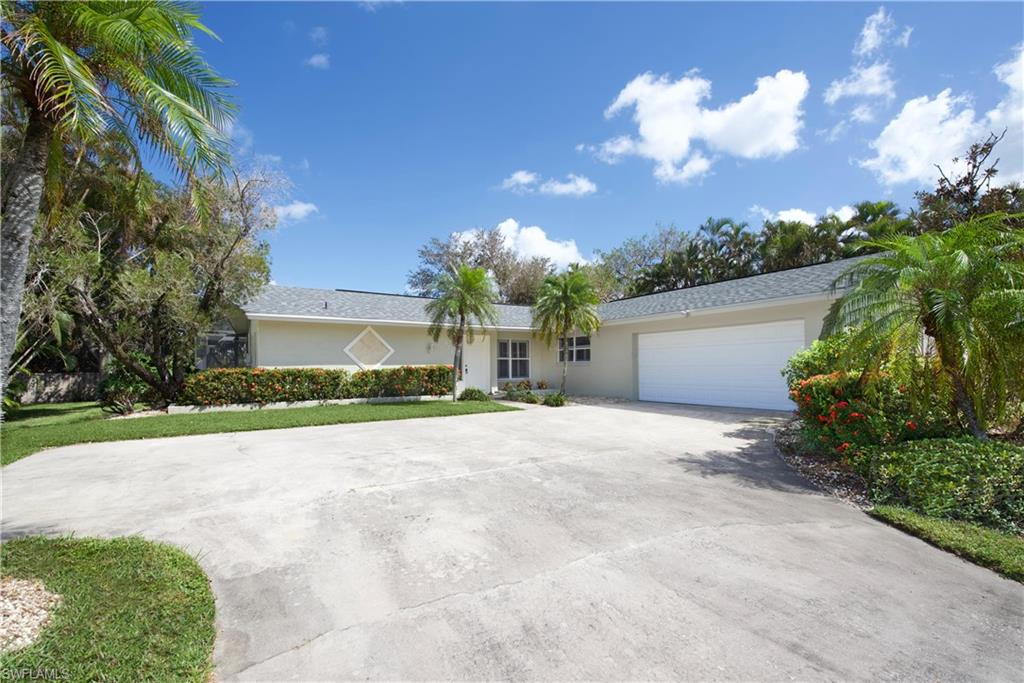 a front view of a house with a yard and a garage