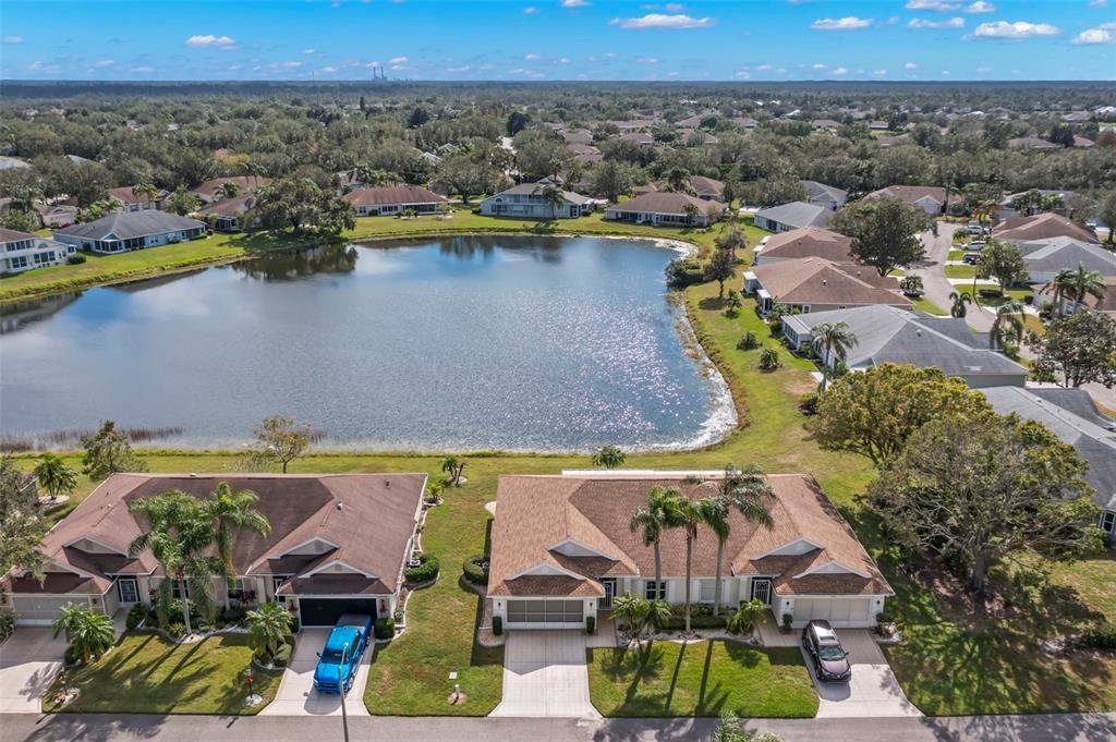 an aerial view of residential houses with outdoor space and swimming pool