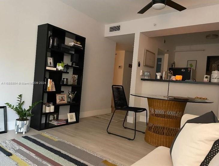 a living room with furniture and a potted plant