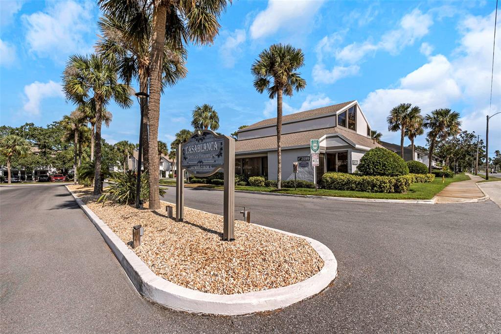 a view of a house with palm trees