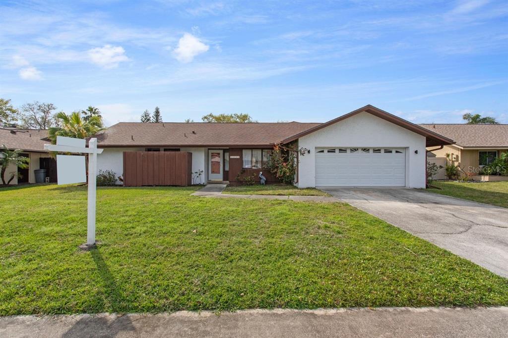 a view of a house with a backyard