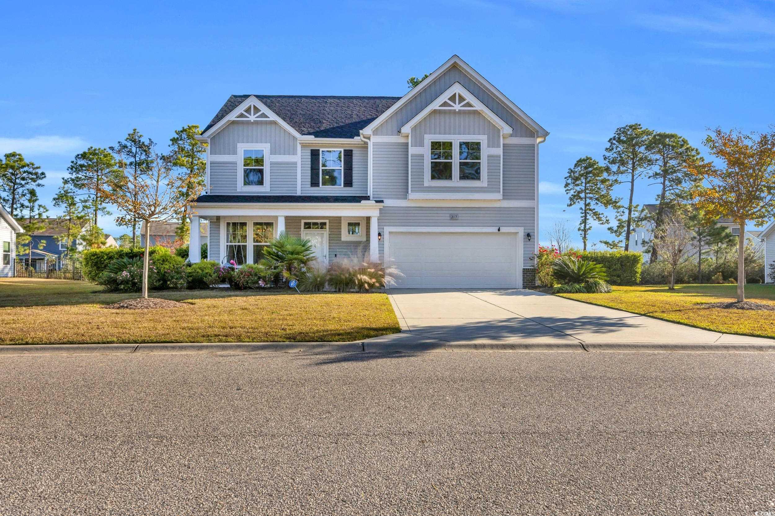 View of front of home with a garage and a front la