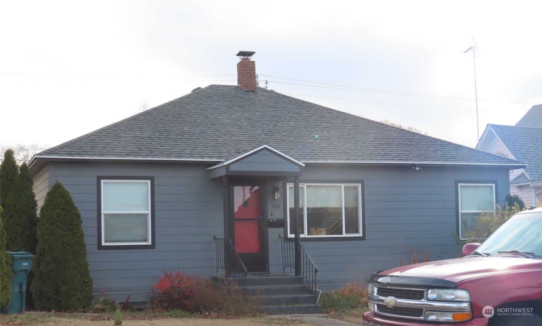 a front view of a house with parking space