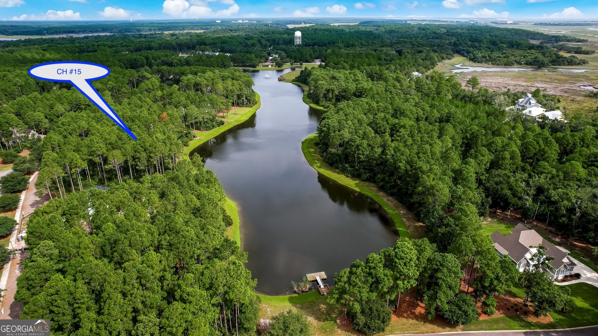 an aerial view of a house with a yard lake outdoor seating and entertaining space