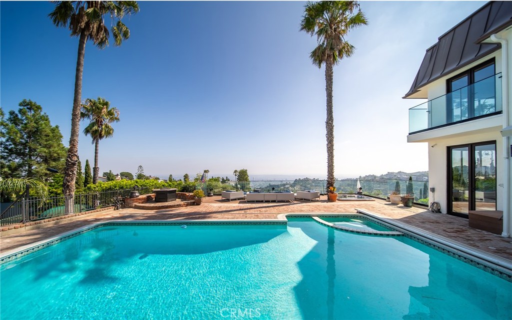 a swimming pool view with a garden space and seating area