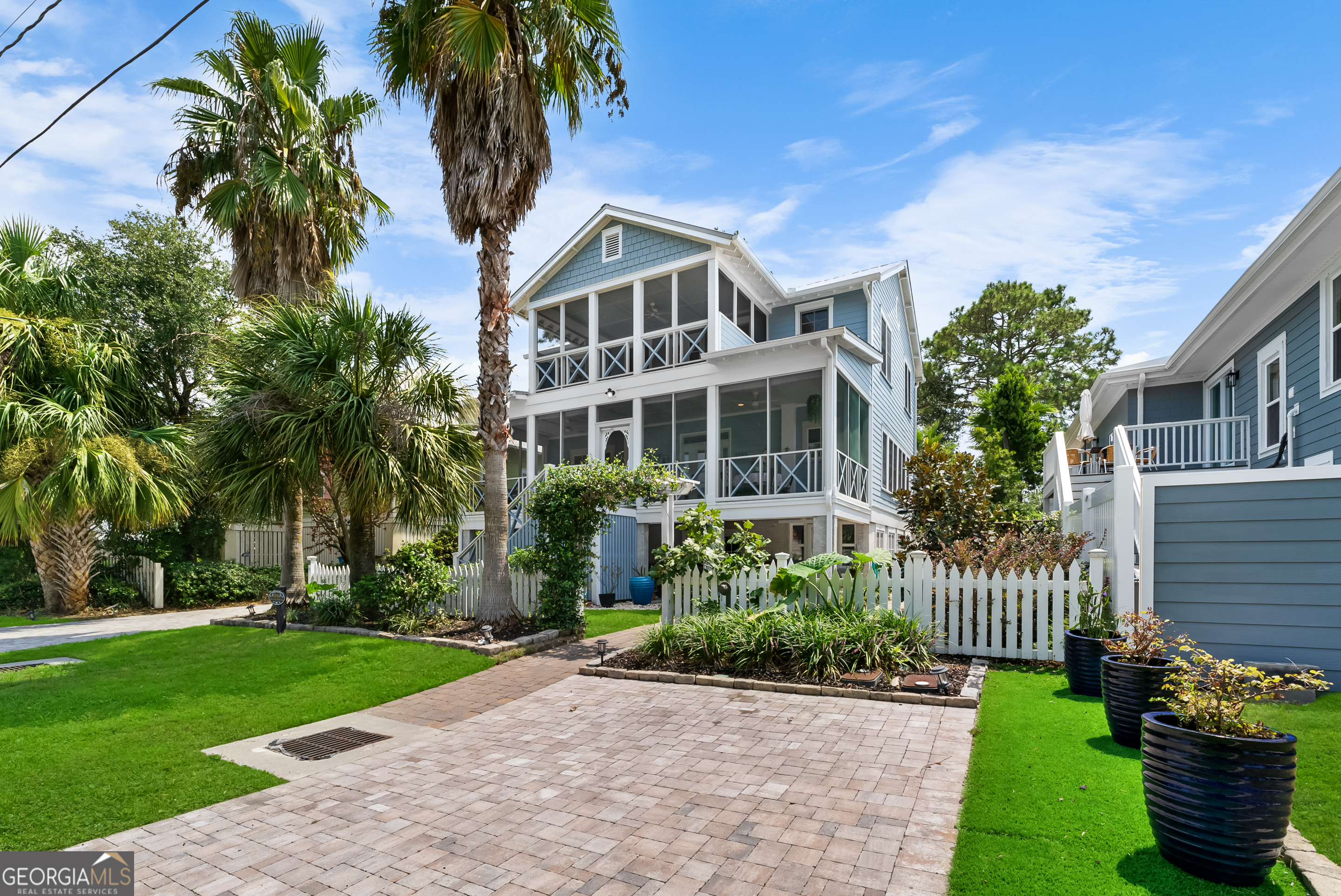 a front view of a house with a garden