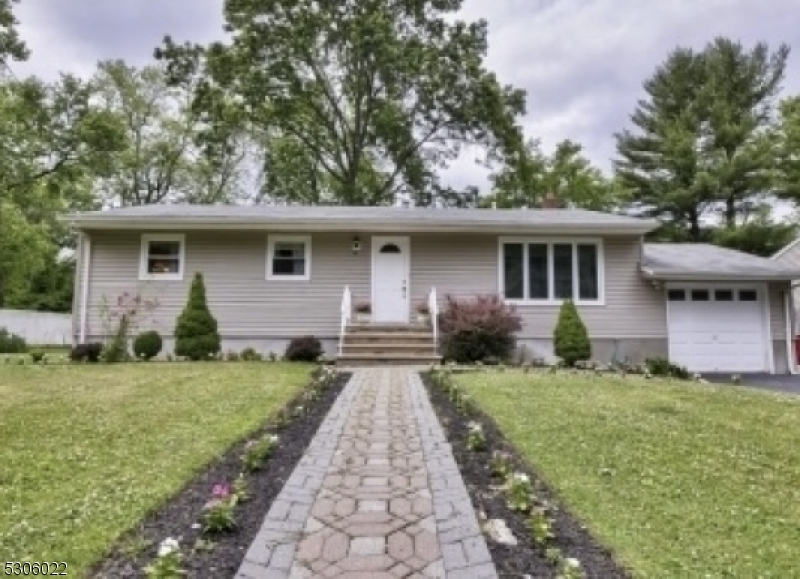 a front view of house with yard and green space