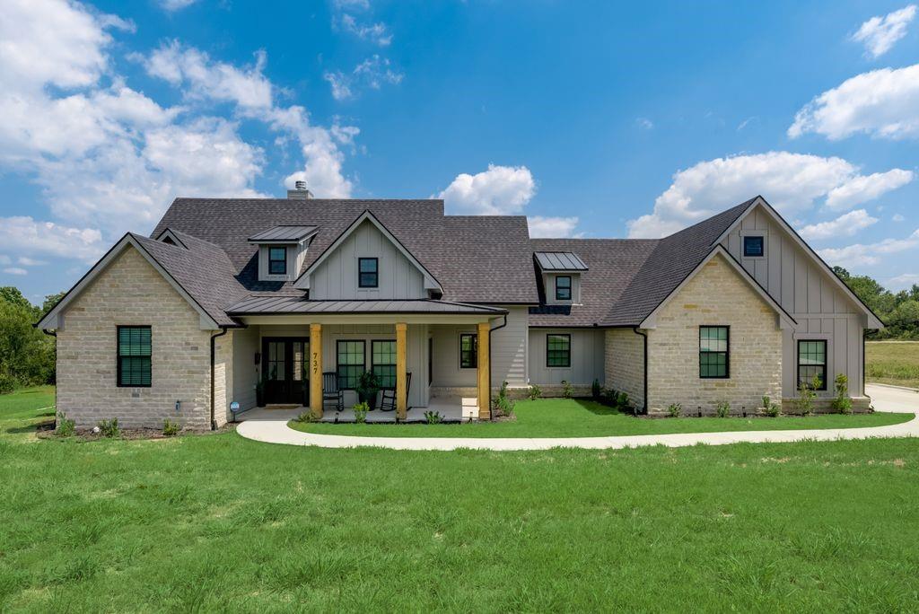 a front view of house with yard and green space