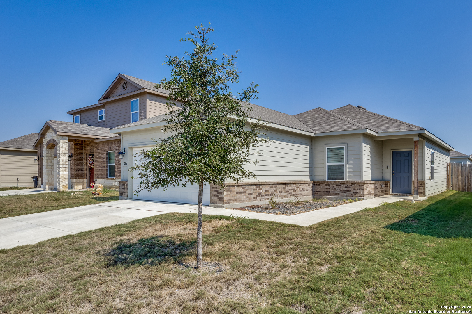 a view of a house with a yard and tree s