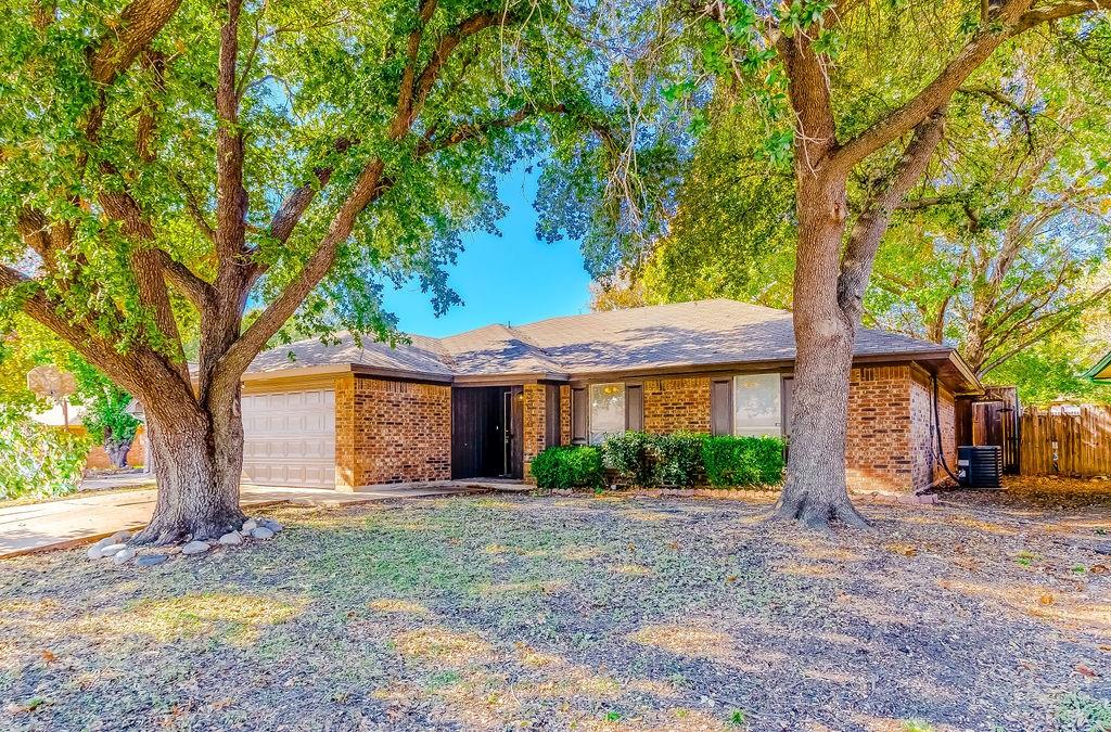 Single story home with central AC unit and a garage