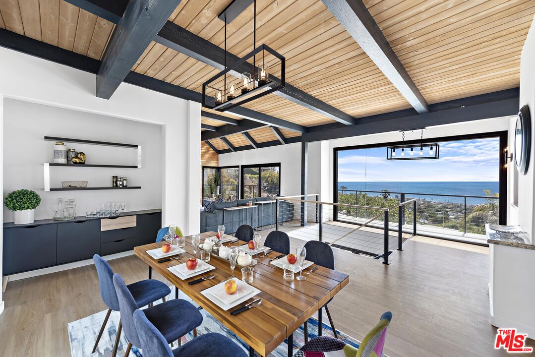 a dining room with wooden floor and furniture