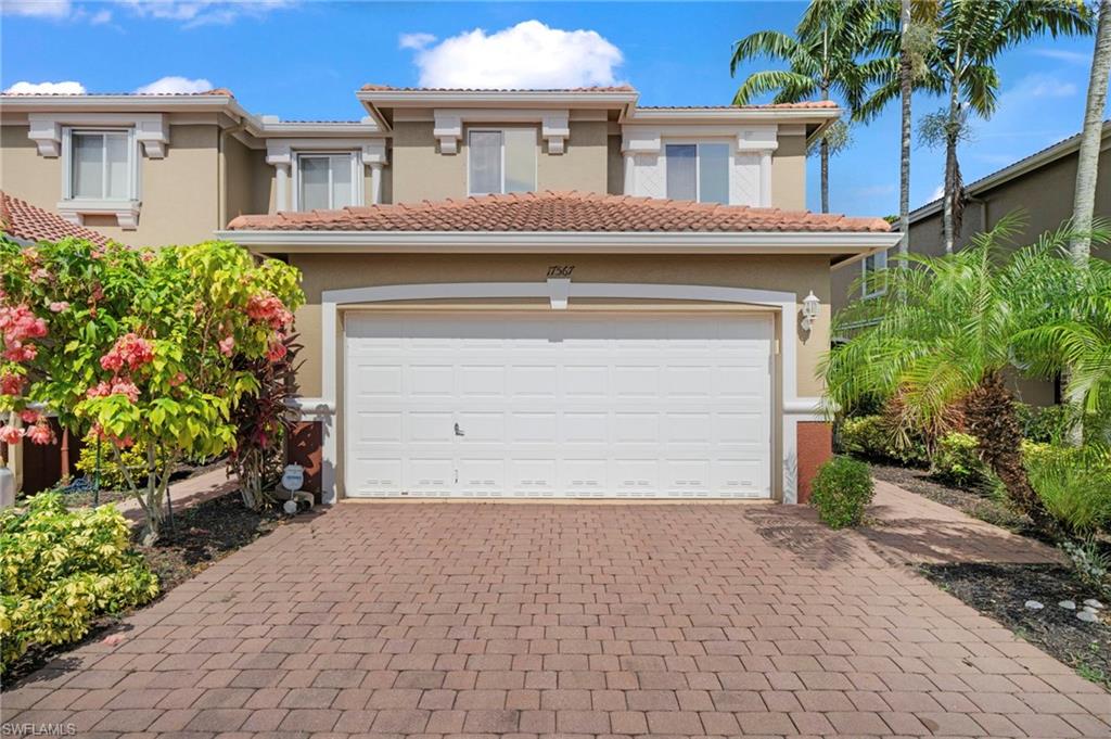 a front view of a house with a yard and garage