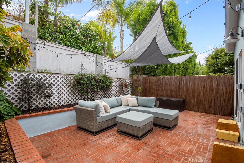 a view of a chairs and tables in the back yard of the house