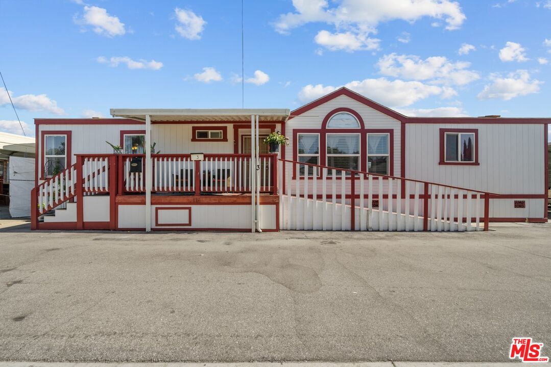 a view of a house with wooden fence