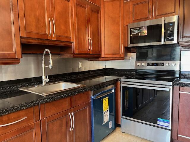 a kitchen with stainless steel appliances granite countertop a stove microwave and cabinets