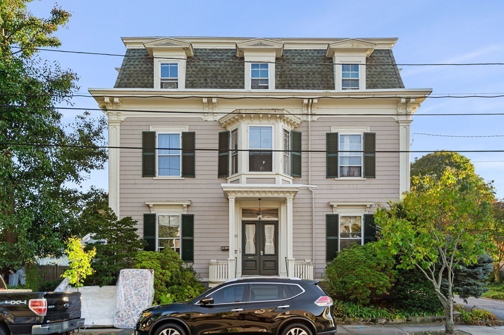 a front view of a house with a garden