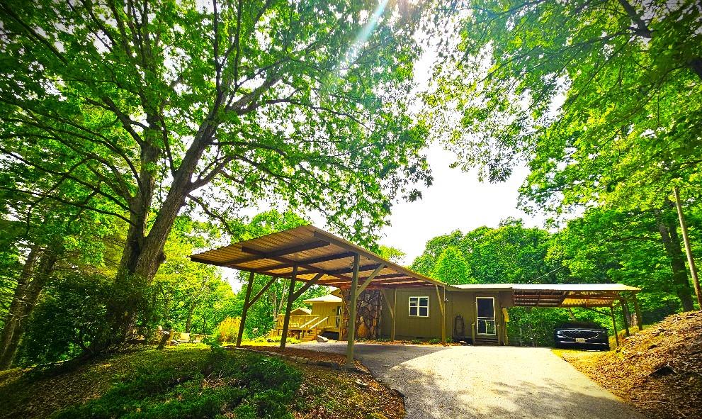 a view of a house with a yard and sitting area