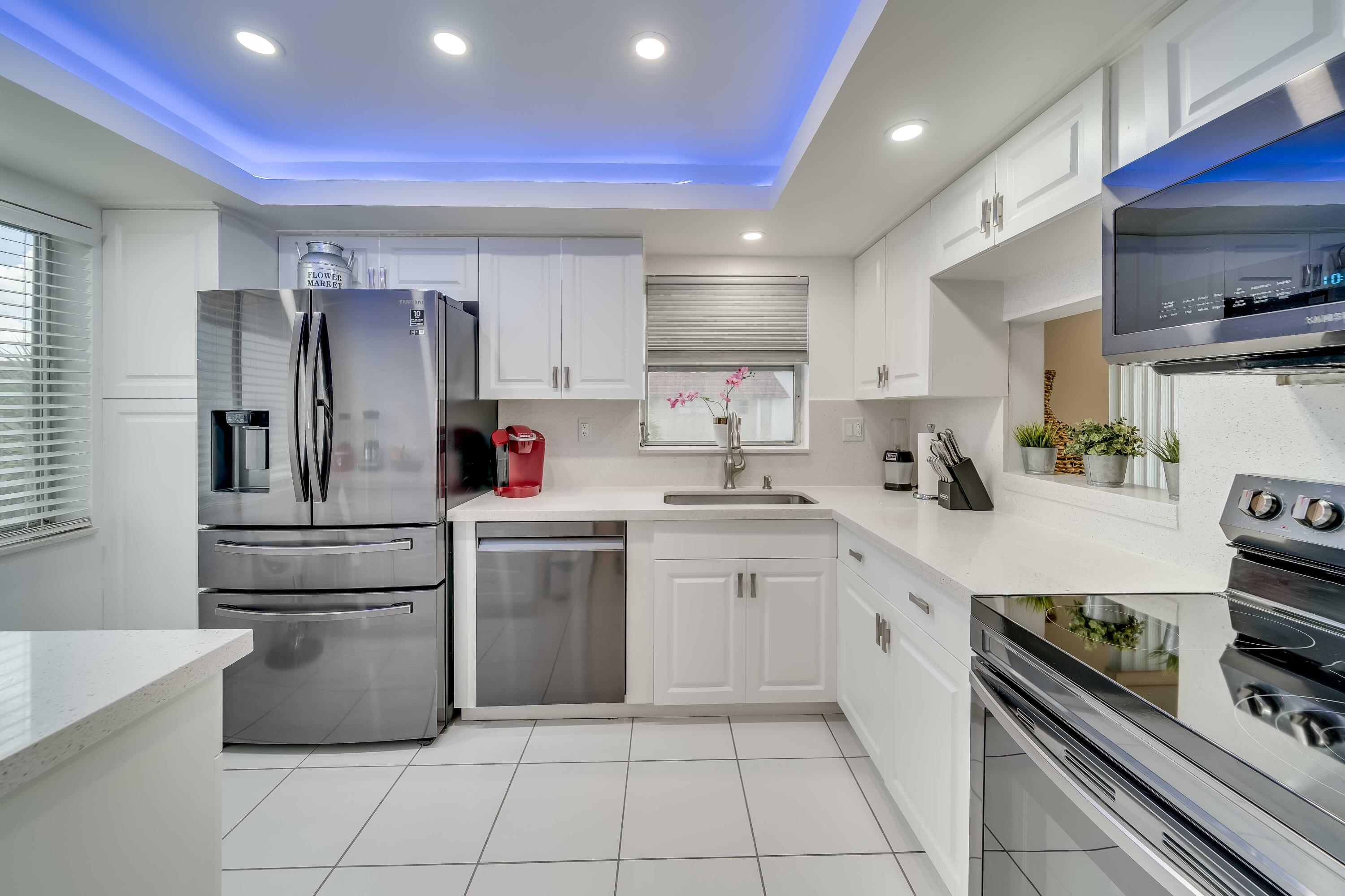 a kitchen with a sink stove and white cabinets