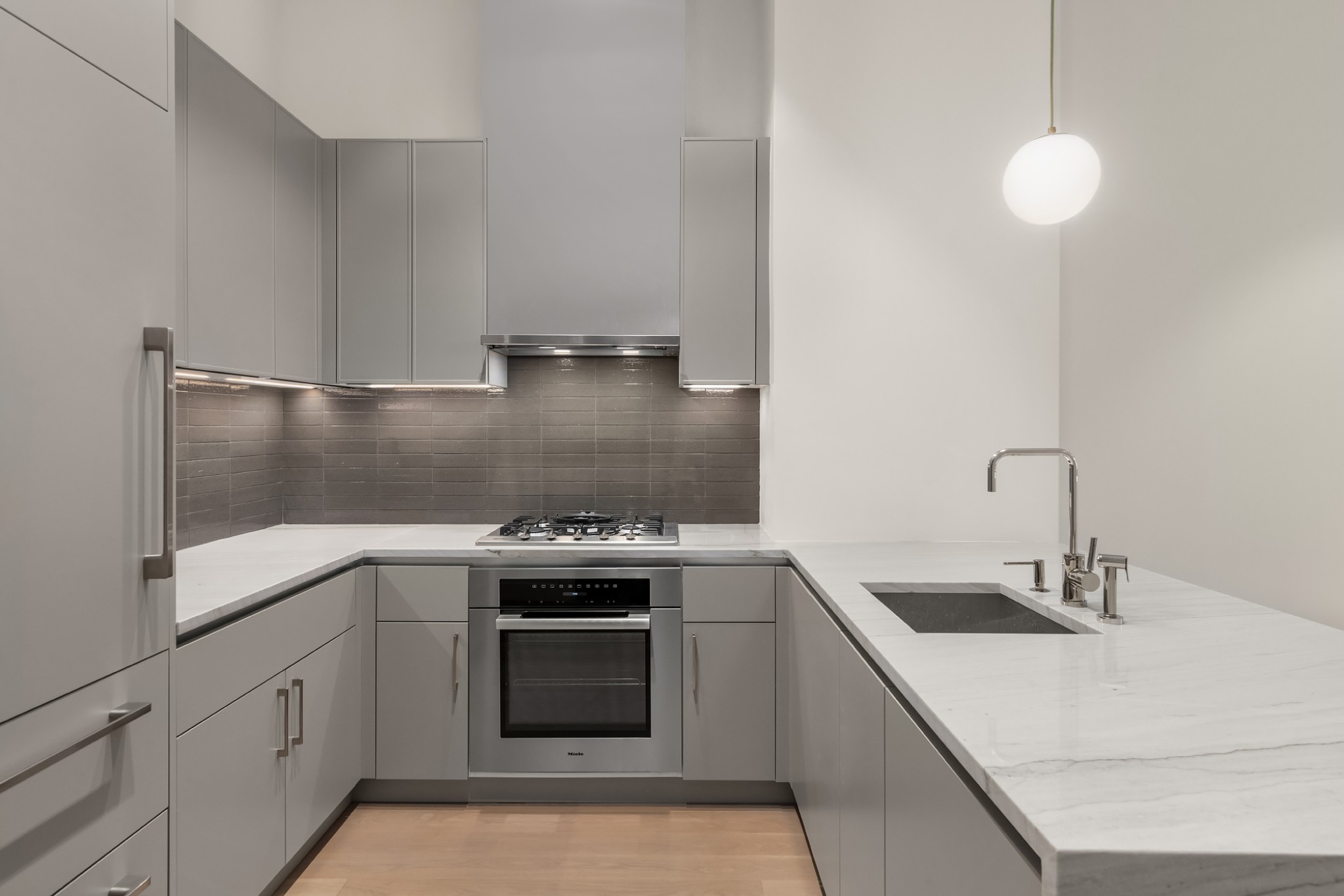 a kitchen with a sink stove and cabinets