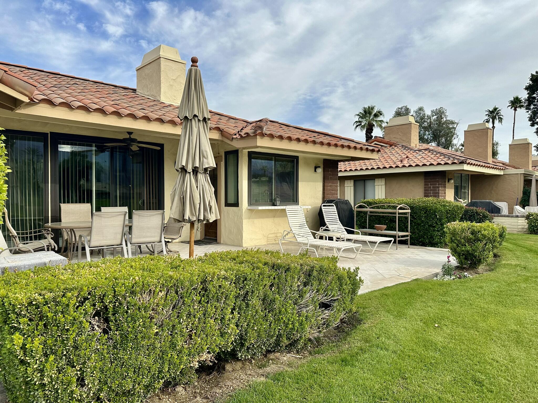 a view of a house with sitting area and garden