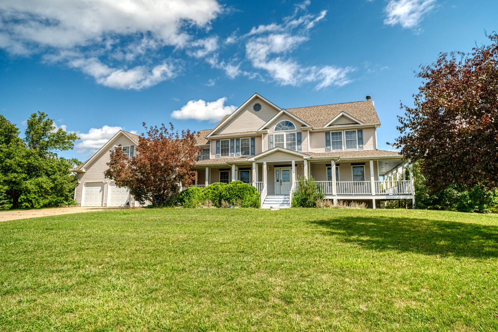 a front view of a house with a garden