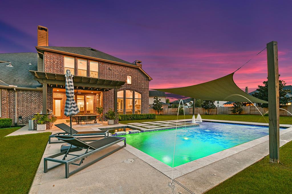 a swimming pool with outdoor seating and yard