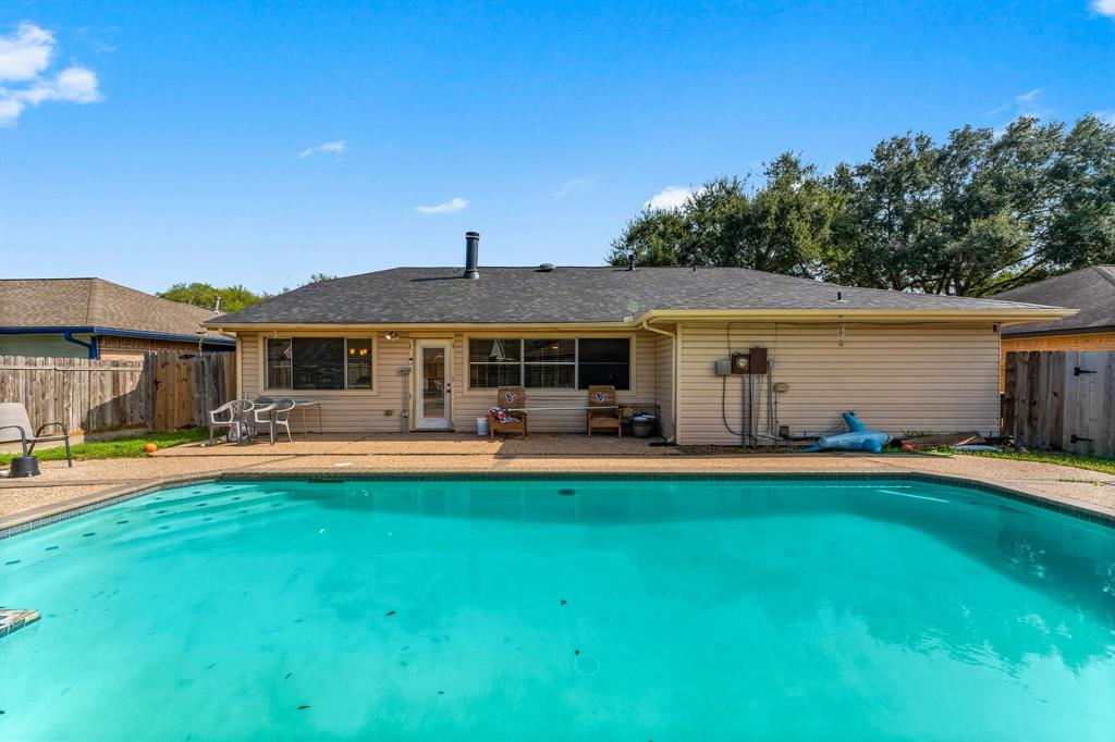 a front view of a house with swimming pool having outdoor seating