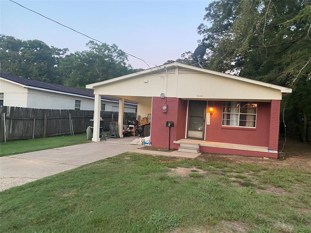 a front view of a house with a yard and porch