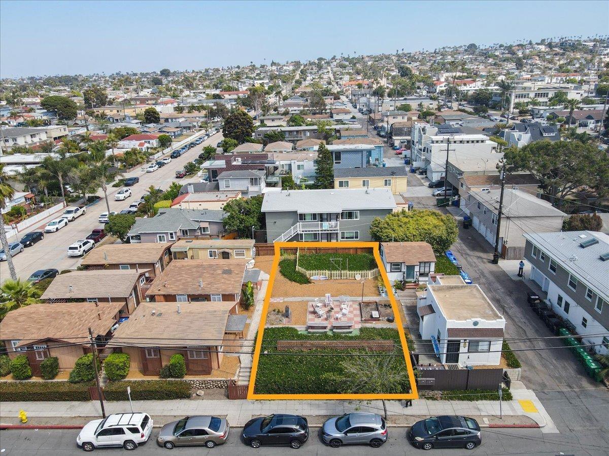 an aerial view of residential houses with yard