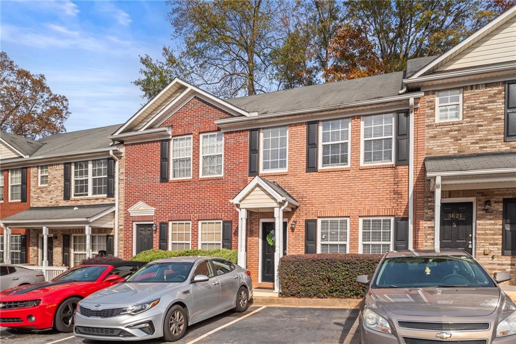 a front view of a house with parking space