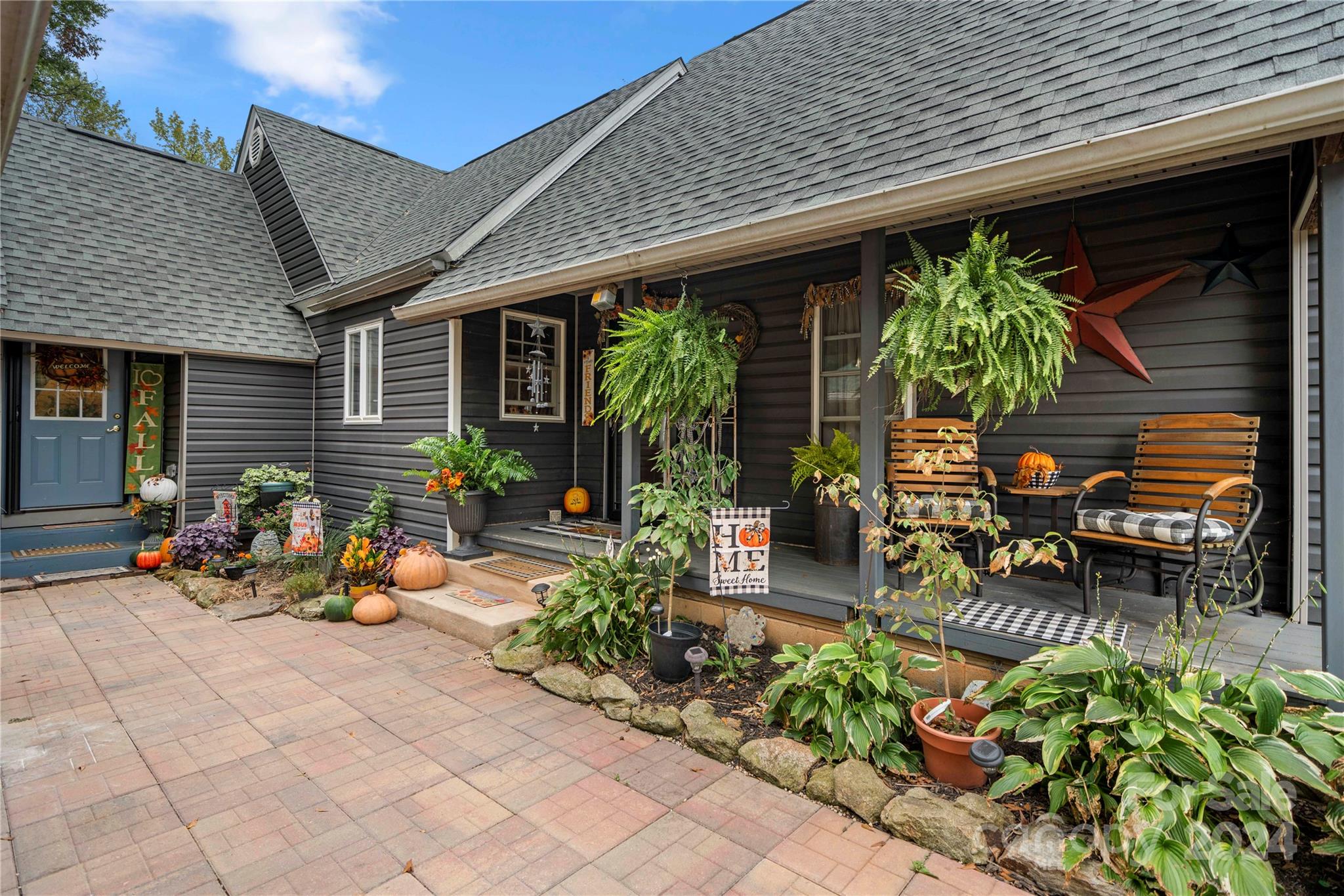 an outdoor sitting area with a table and chairs and potted plants