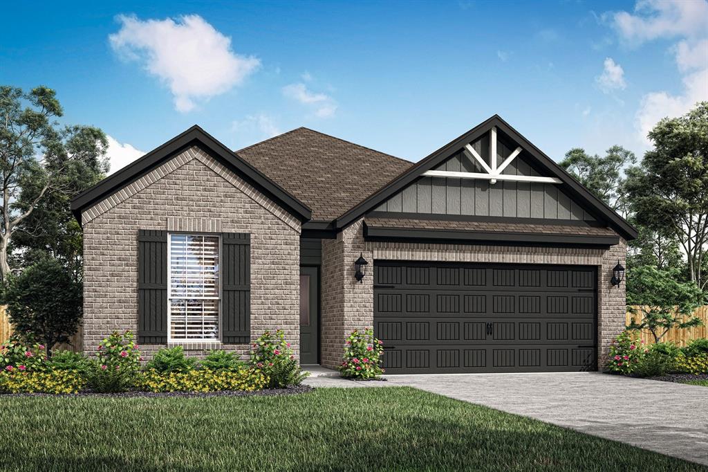 a front view of a house with a garden and garage