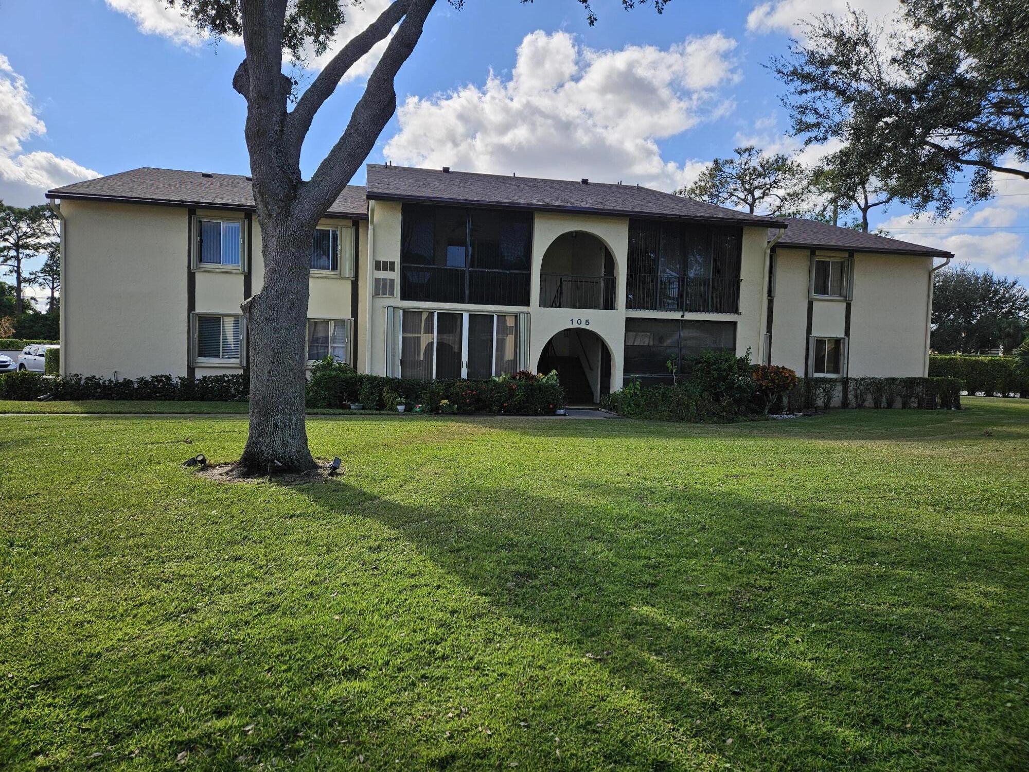 a view of a house with backyard and porch