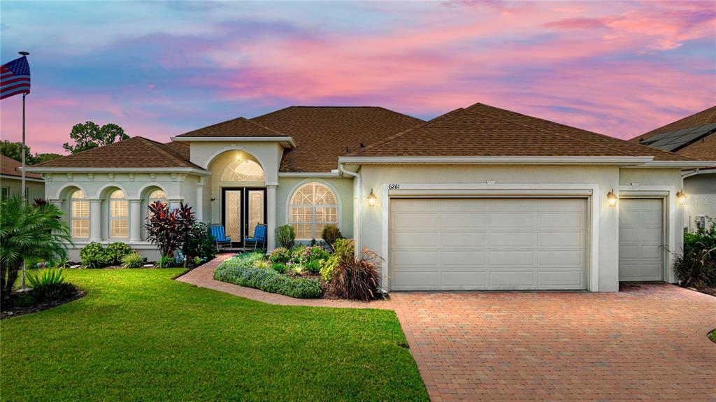 a front view of a house with a yard and garage