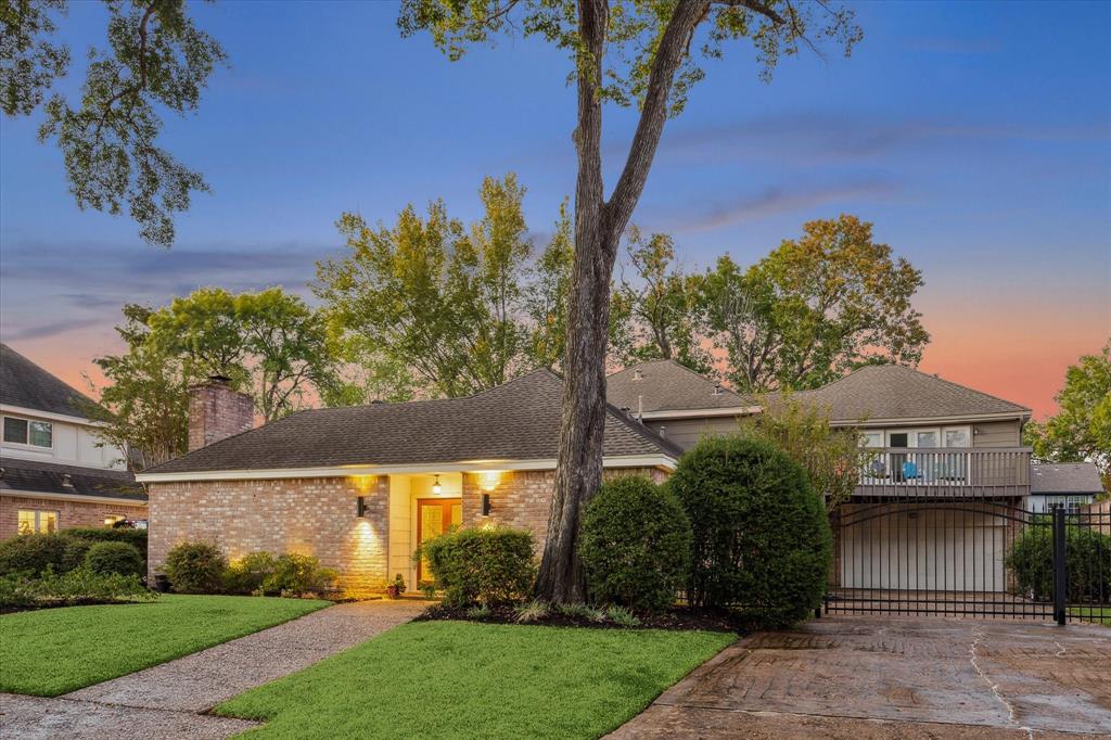 a view of a house with a tree in a yard