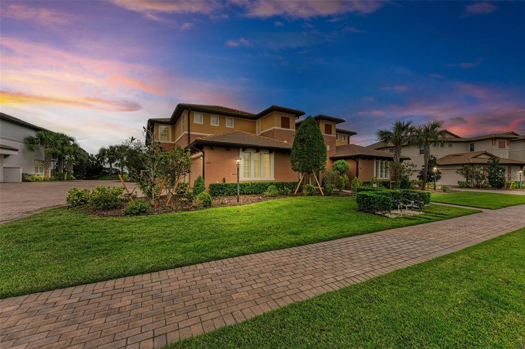 a front view of a house with a garden